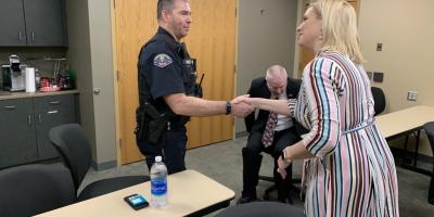 ashley hinson shakes hands with law enforcement