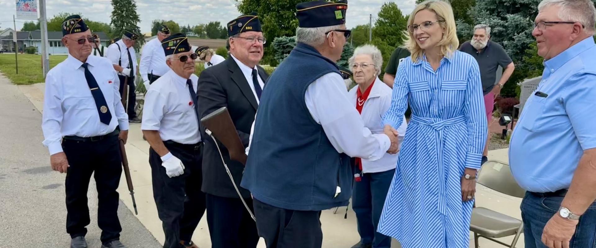 Representative Hinson shaking hands with a veteran