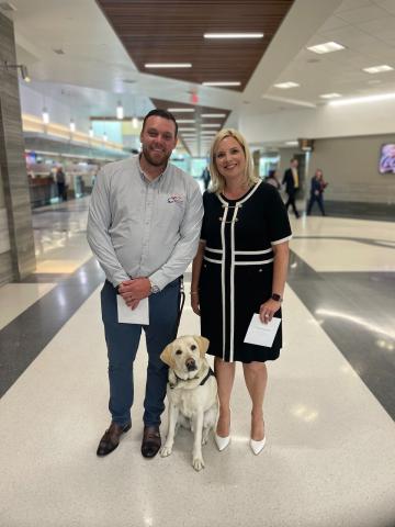 Image of Trent, Tracer and Rep. Ashley Hinson at the Eastern Iowa Airport.